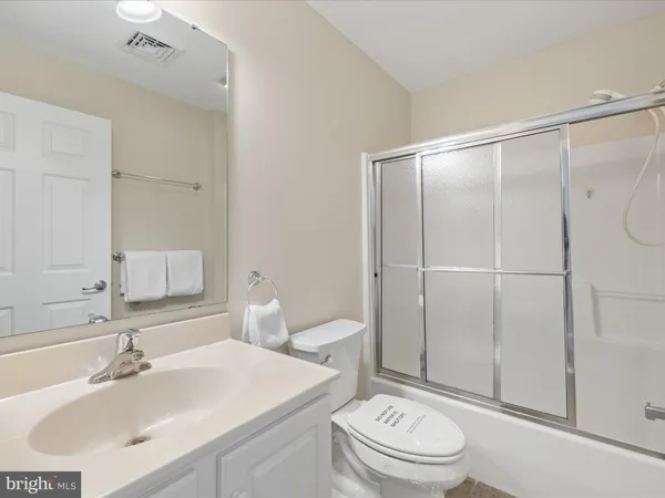 front view of a house with a yard and potted plants