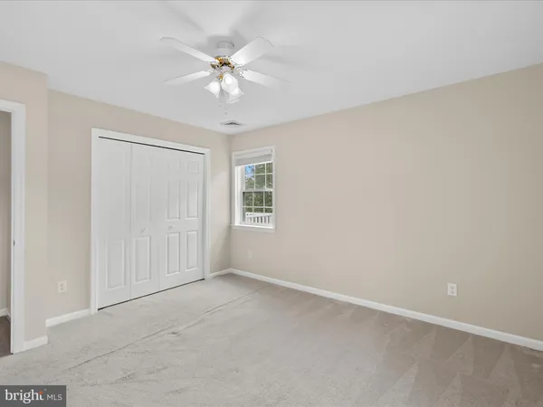 a bedroom with furniture and large window