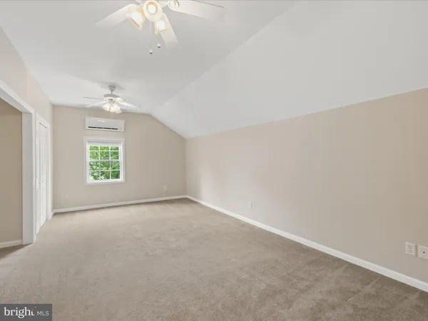a view of a house with a big yard and large tree