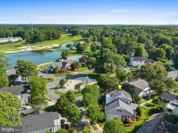 an aerial view of a city with lots of residential buildings ocean and mountain view in back