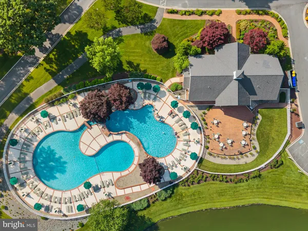 an aerial view of a house with a garden and lake view