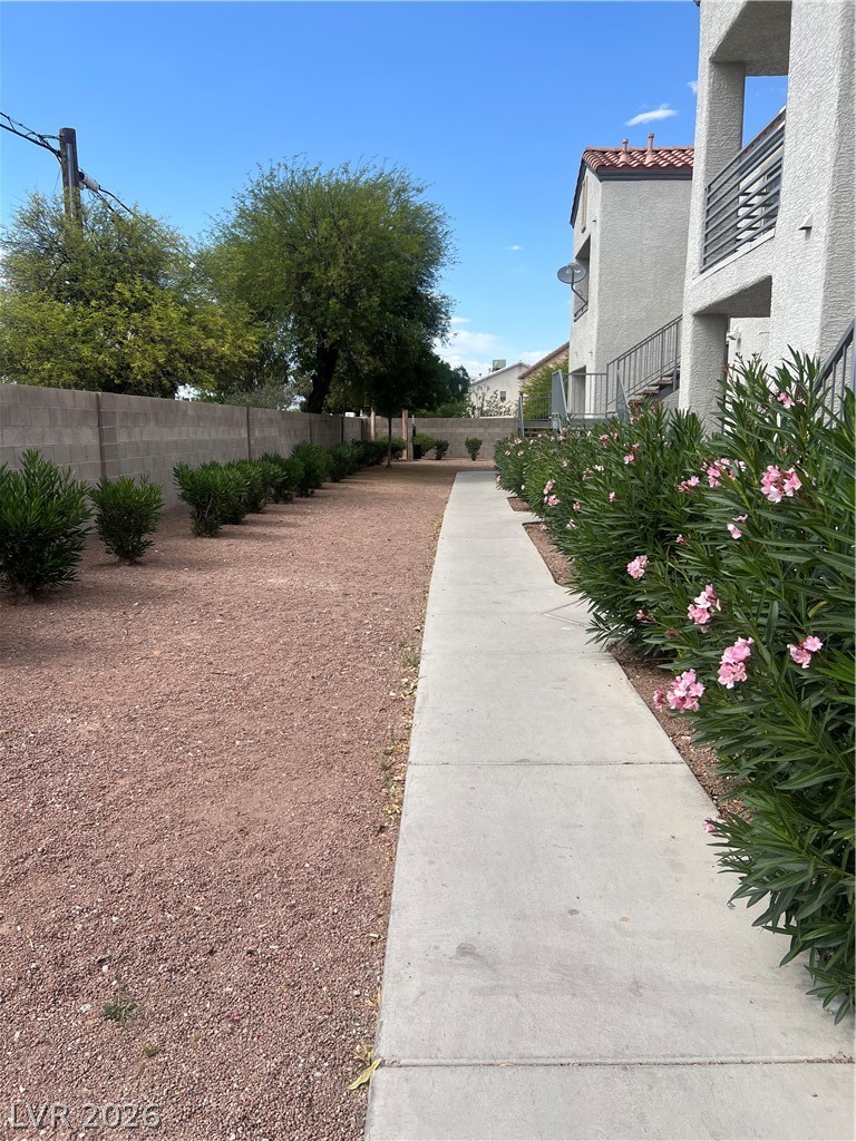 3318 North Decatur Boulevard, Unit 1174 Las Vegas, NV 89130 - Photo 17 of 23 This inviting pathway leads to charming residences, showcasing functional outdoor space.