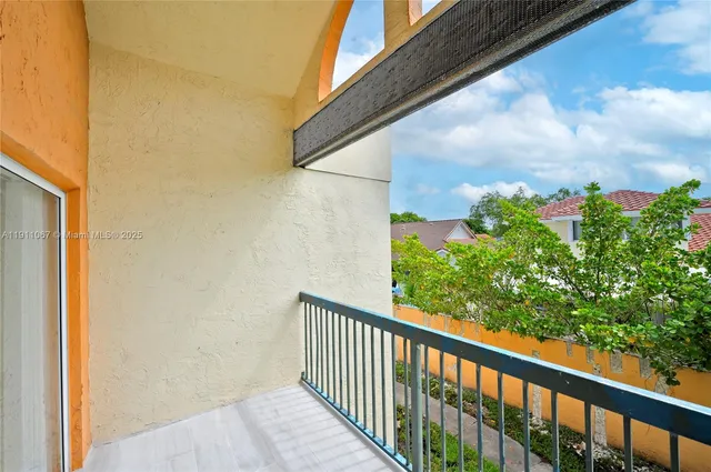 a view of a balcony with flower plants