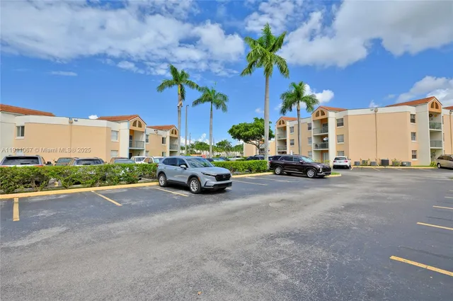 a view of a street with couple of cars parked in front of it