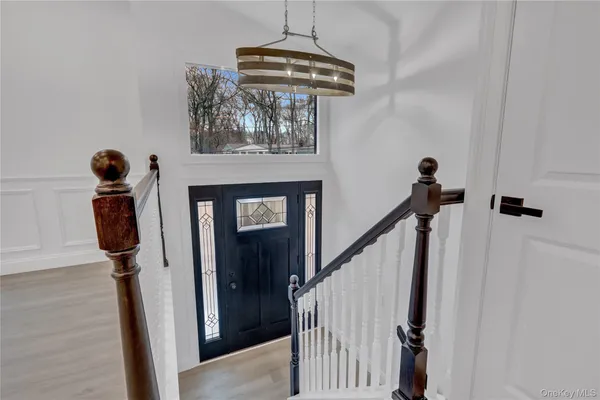 a view of an entryway with wooden floor