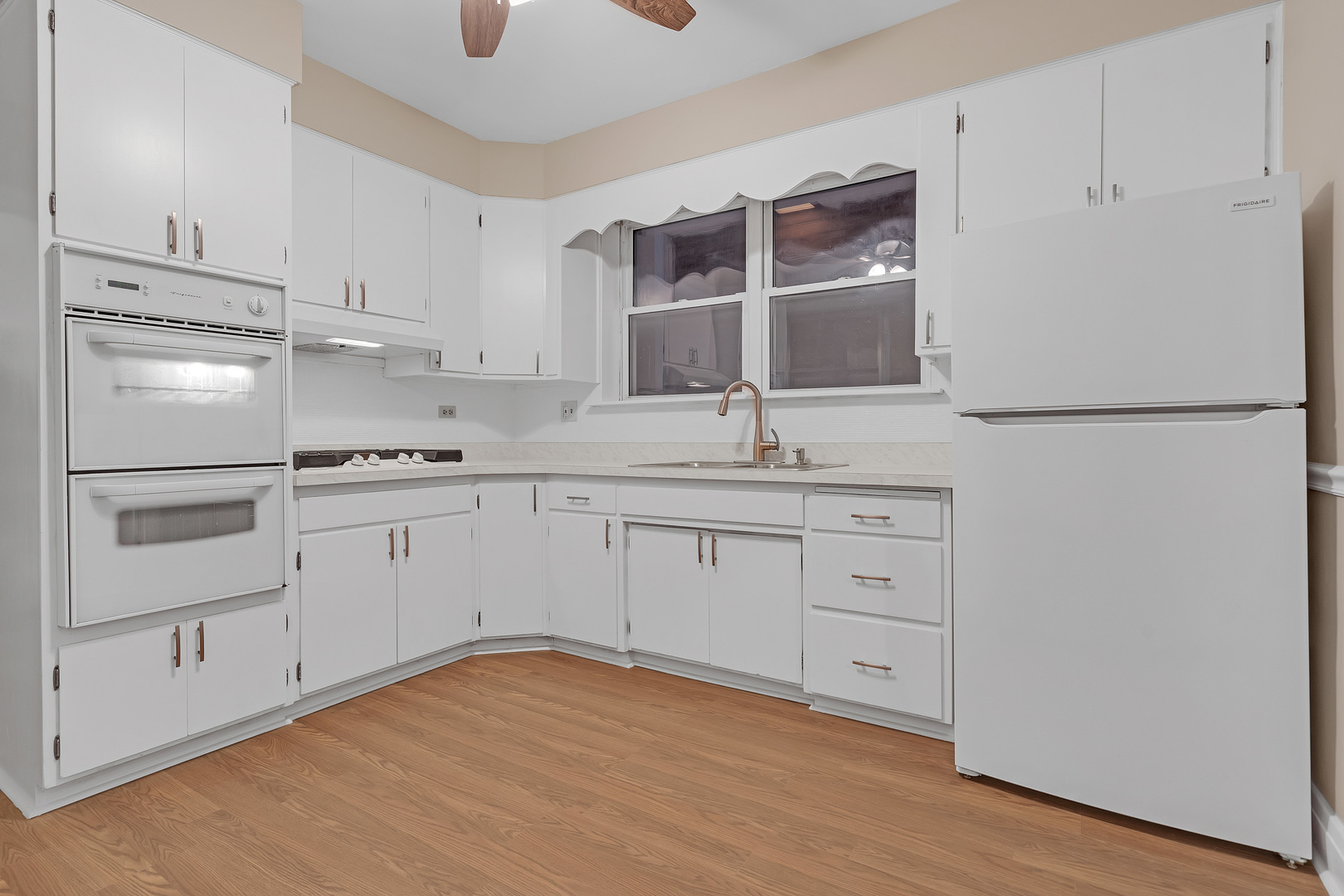 6138 North Meade Avenue Chicago, IL 60646 - Photo 11 of 32 a kitchen with white cabinets and white appliances