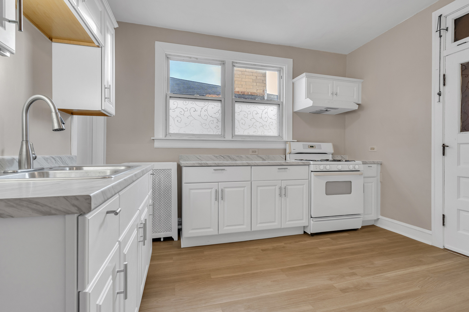 6138 North Meade Avenue Chicago, IL 60646 - Photo 24 of 32 a kitchen with granite countertop white cabinets and white appliances