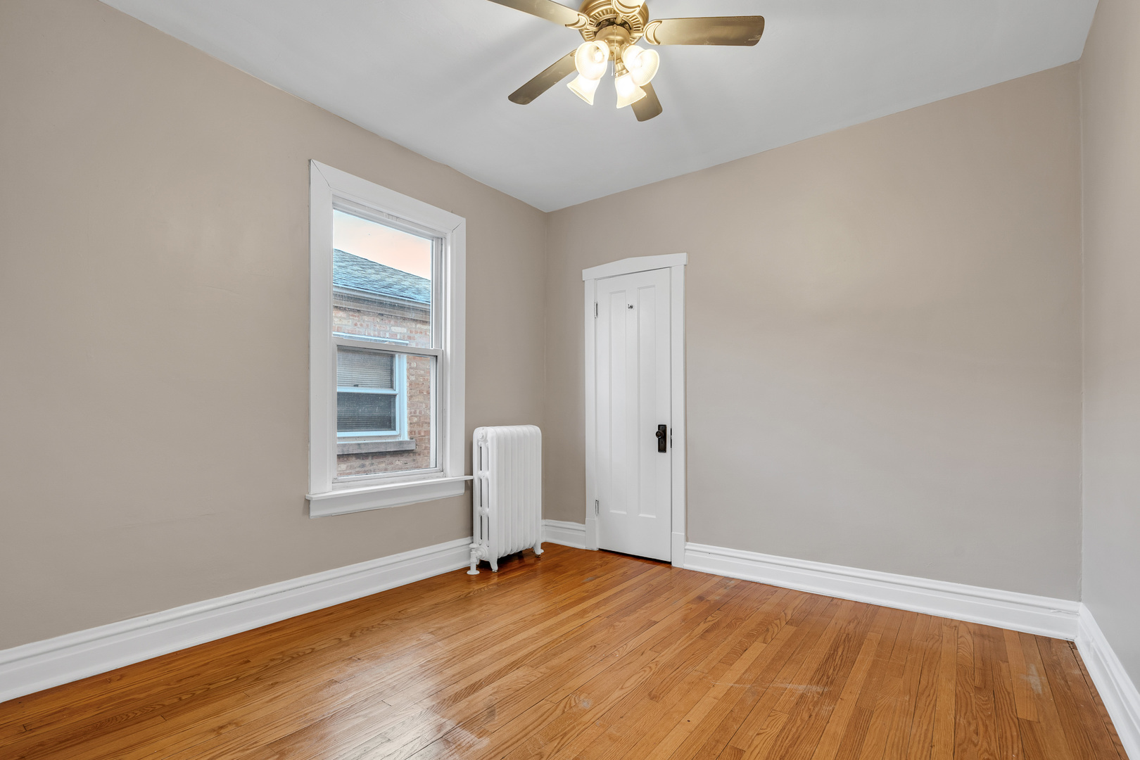 6138 North Meade Avenue Chicago, IL 60646 - Photo 8 of 32 an empty room with wooden floor and windows