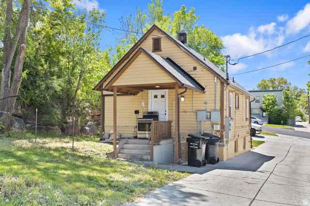 661 East 600 North Logan, UT 84321 - Photo 6 of 15 Yellow siding exterior with a covered porch and white entry door