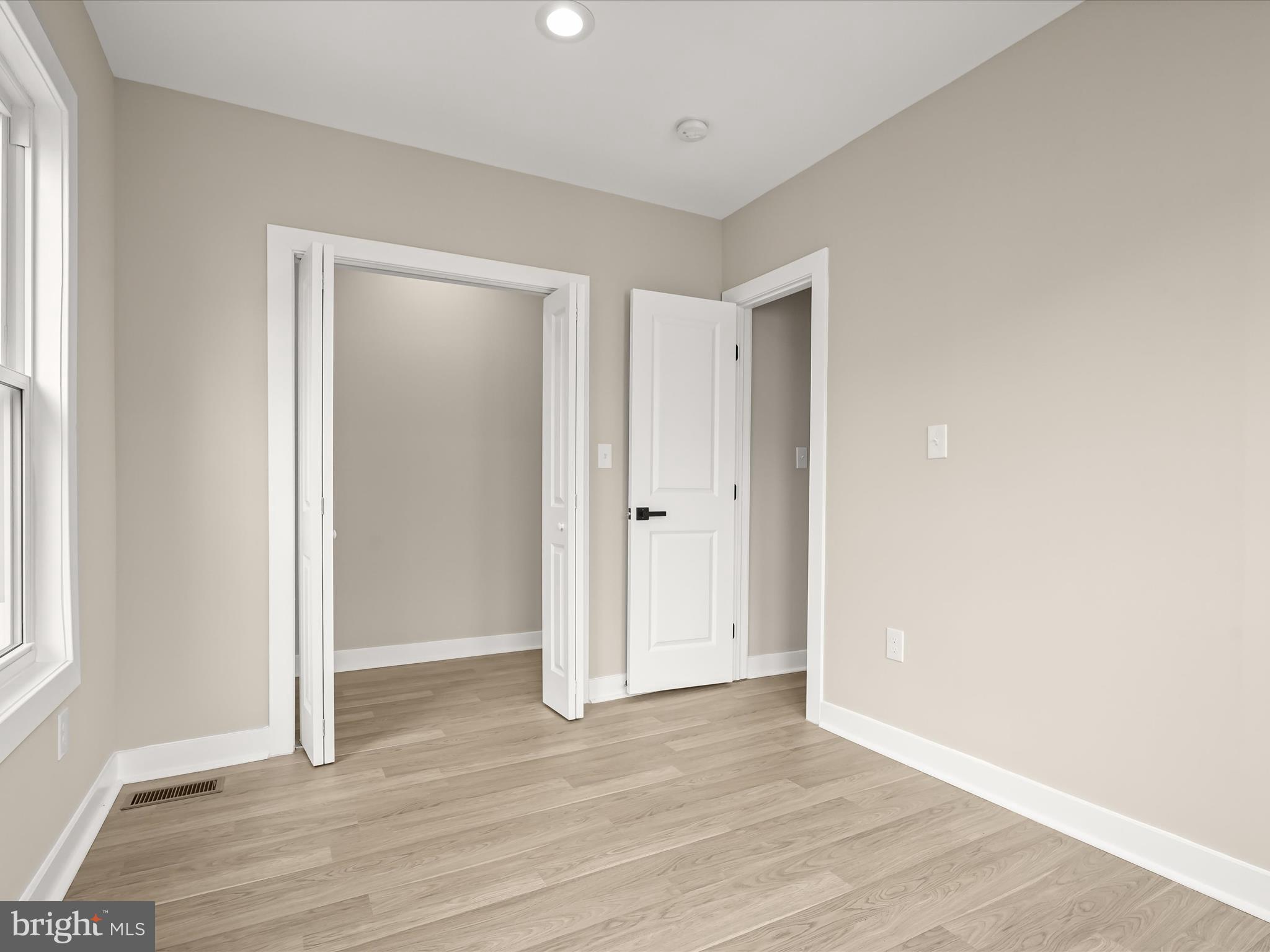 5728 8th Street Northwest Washington, DC 20011 - Photo 19 of 50 an empty room with wooden floor & windows