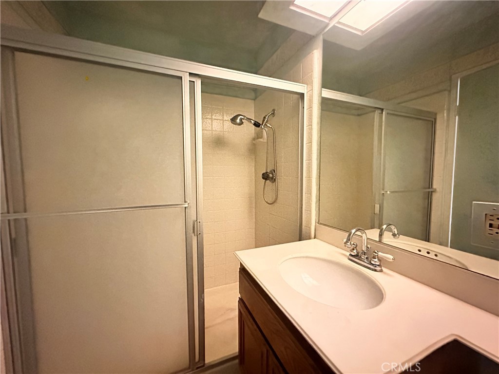 7 Wilderness Place Pomona, CA 91766 - Photo 16 of 26 a bathroom with a sink and shower