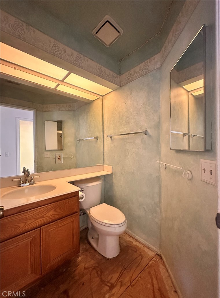 7 Wilderness Place Pomona, CA 91766 - Photo 17 of 26 a bathroom with a double vanity sink toilet and a mirror