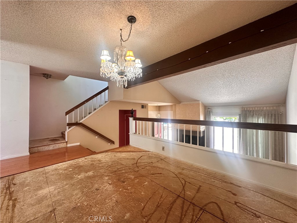 7 Wilderness Place Pomona, CA 91766 - Photo 8 of 26 a view of a livingroom with furniture a chandelier and wooden floor