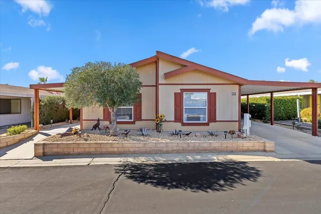 a view of a house with backyard and sitting area