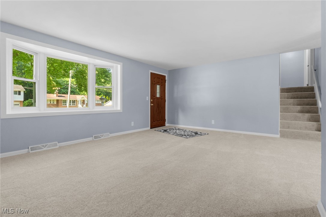 4895 3rd Street Northwest Canton, OH 44708 - Photo 8 of 27 Carpeted foyer featuring stairway and baseboards