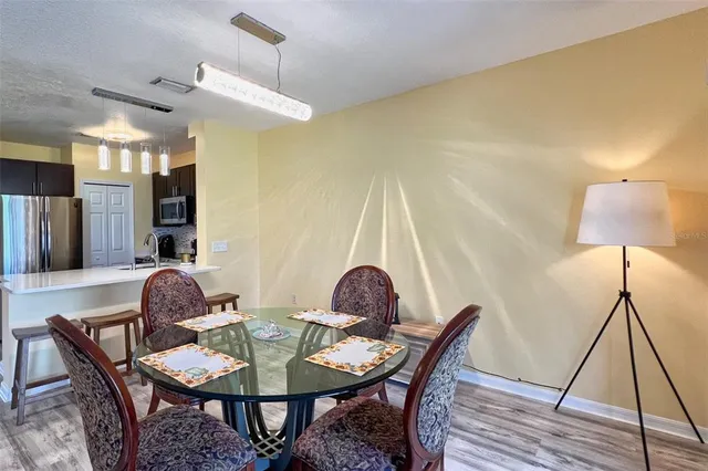 a dining room with furniture and wooden floor