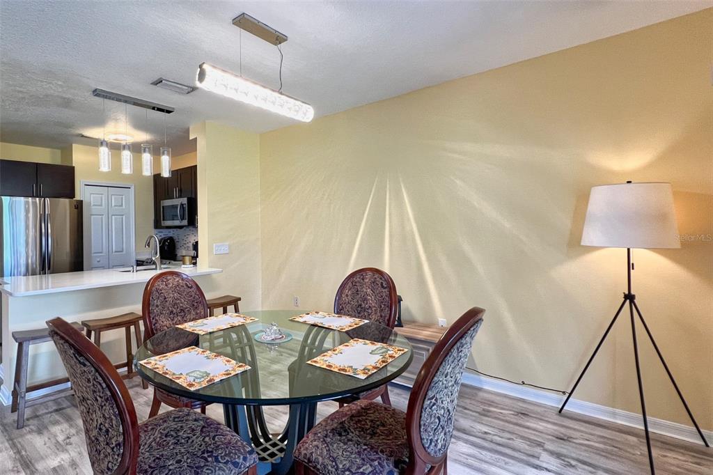 14741 Amberjack Terrace Lakewood Ranch, FL 34202 - Photo 11 of 48 a dining room with furniture and wooden floor