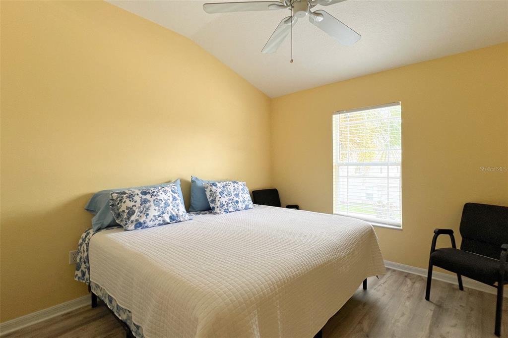 14741 Amberjack Terrace Lakewood Ranch, FL 34202 - Photo 26 of 48 a bedroom with a bed and a chandelier