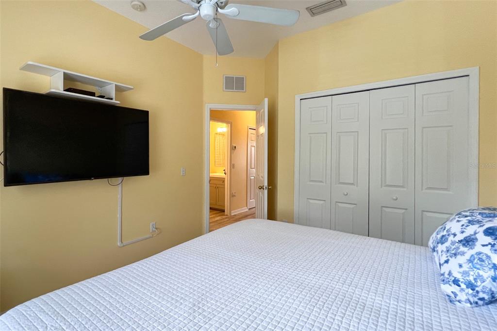 14741 Amberjack Terrace Lakewood Ranch, FL 34202 - Photo 28 of 48 a bedroom with a bed and a flat screen tv