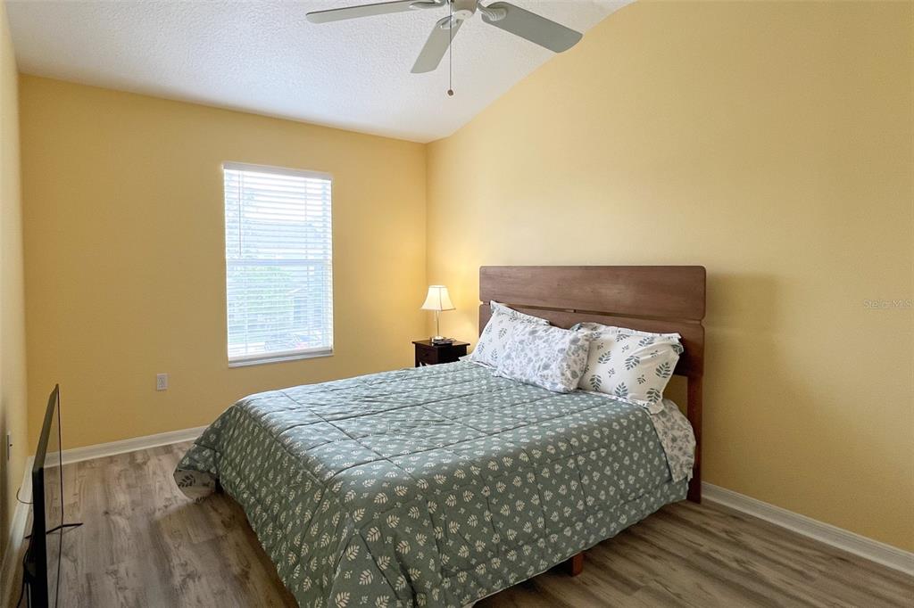 14741 Amberjack Terrace Lakewood Ranch, FL 34202 - Photo 30 of 48 a bedroom with a bed and wooden floor