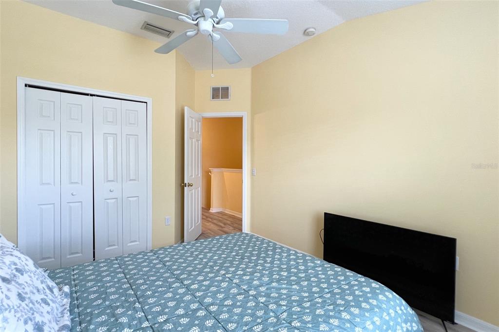 14741 Amberjack Terrace Lakewood Ranch, FL 34202 - Photo 32 of 48 a bedroom with a bed and a chandelier