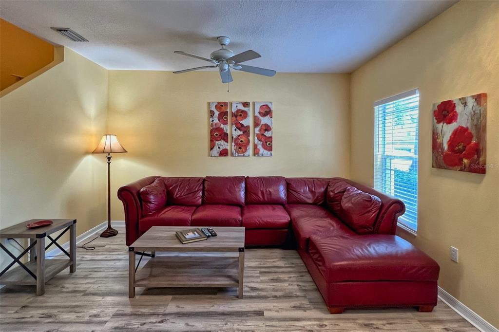 14741 Amberjack Terrace Lakewood Ranch, FL 34202 - Photo 6 of 48 a blue couch sitting in a living room with a rug