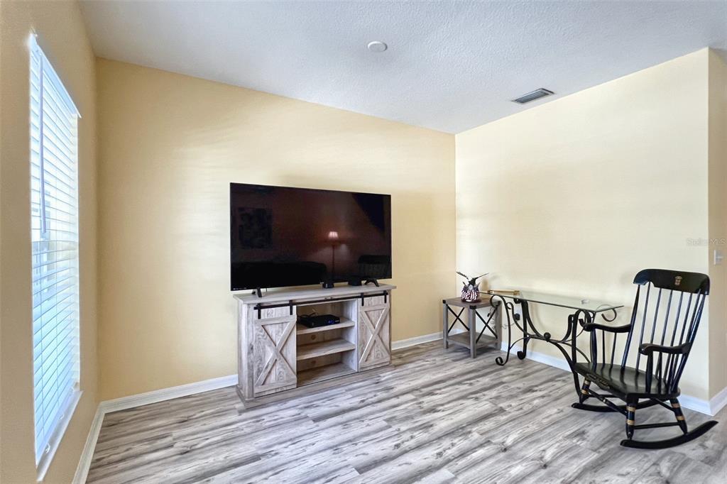 14741 Amberjack Terrace Lakewood Ranch, FL 34202 - Photo 7 of 48 a view of a livingroom with furniture and a flat screen tv
