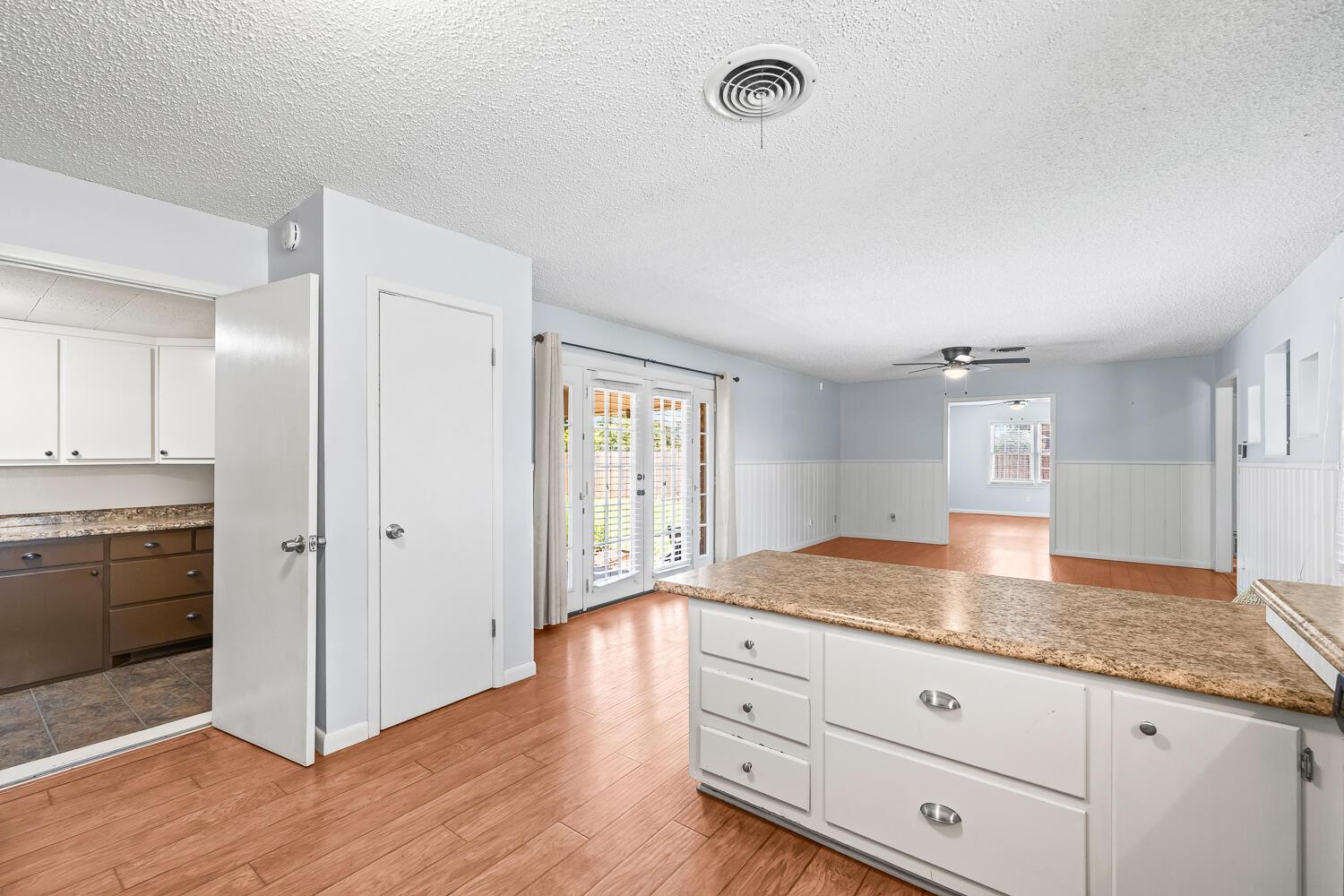 5204 7th Street Lubbock, TX 79416 - Photo 11 of 29 a kitchen with granite countertop cabinets and wooden floor