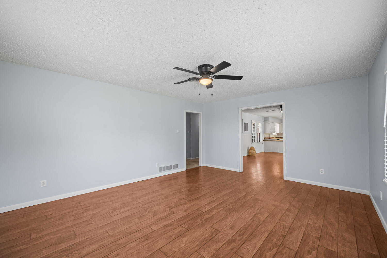 5204 7th Street Lubbock, TX 79416 - Photo 13 of 29 a view of empty room with wooden floor and ceiling fan