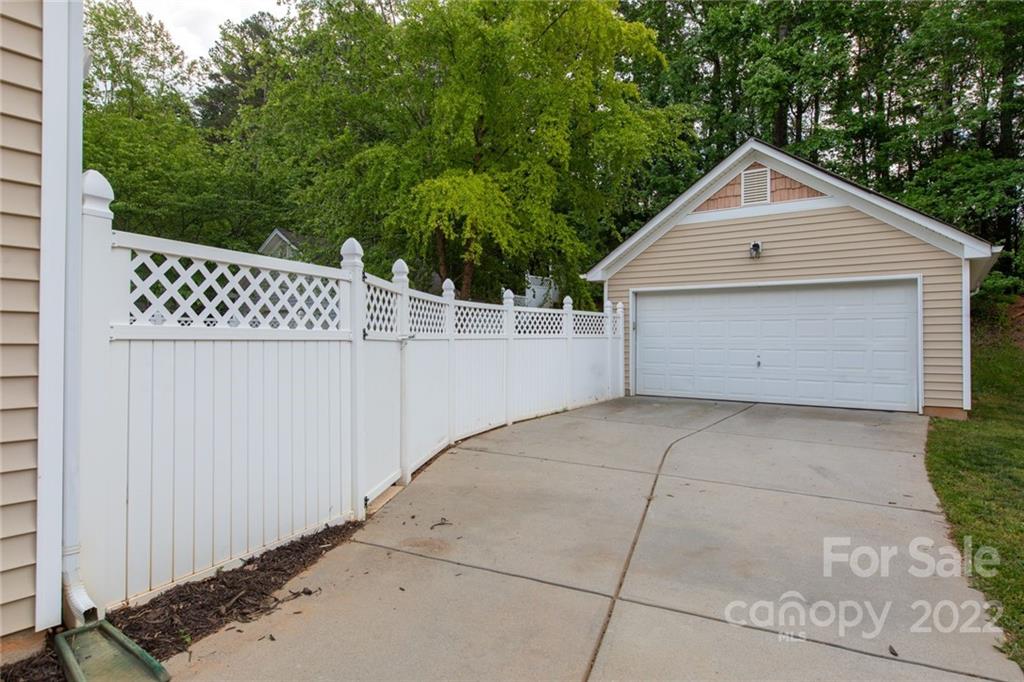 10322 Caldwell Depot Road Cornelius, NC 28031 - Photo 13 of 21 a view of backyard of house with wooden fence