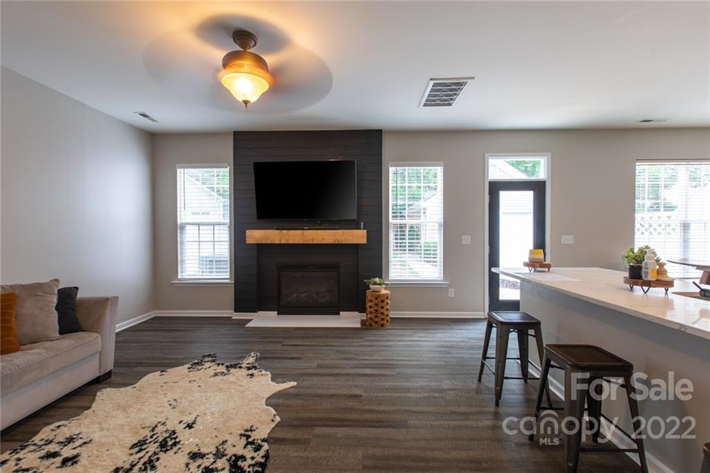 10322 Caldwell Depot Road Cornelius, NC 28031 - Photo 3 of 21 a living room with furniture flat screen tv and wooden floor