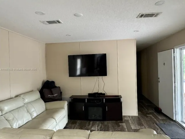 a view of a livingroom with furniture and a flat screen tv