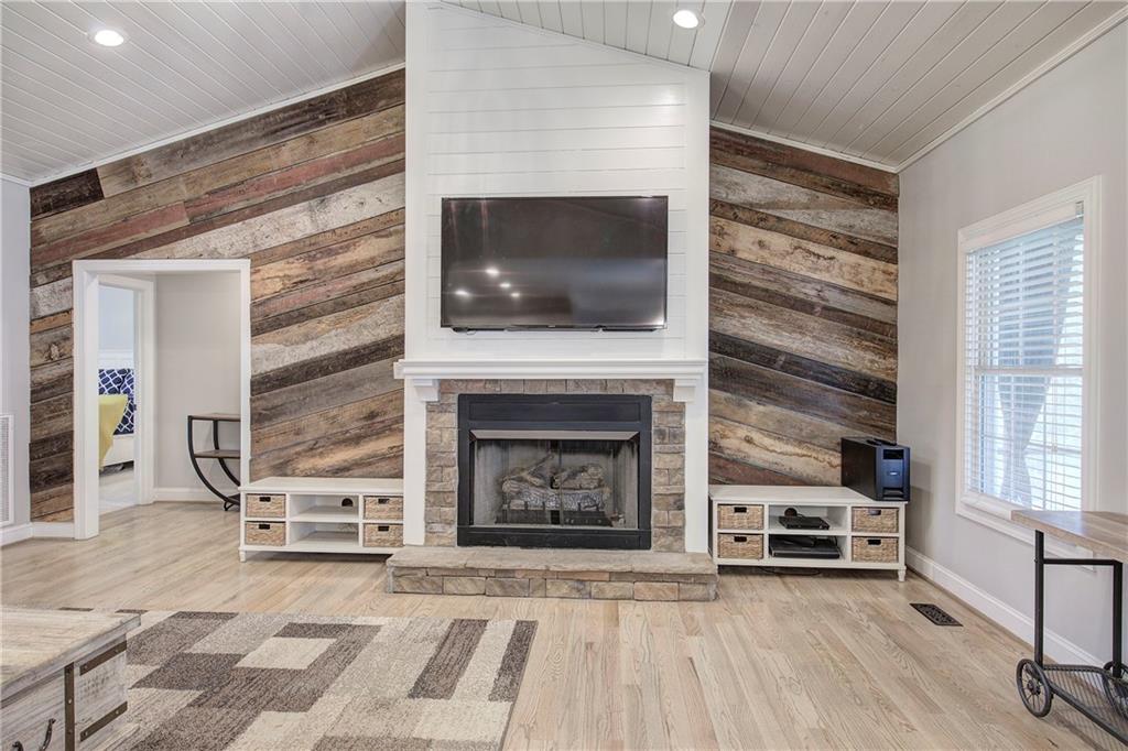 1005 Harmony Road Southeast Aragon, GA 30104 - Photo 11 of 40 a living room with a fireplace and a flat screen tv