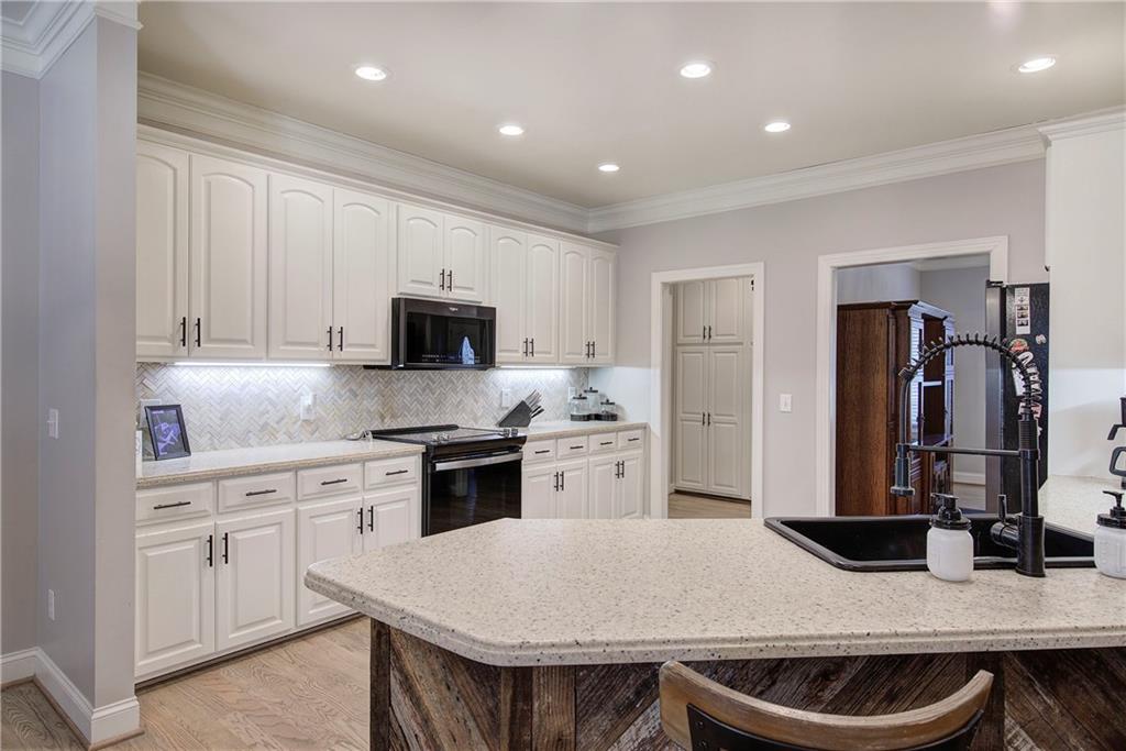 1005 Harmony Road Southeast Aragon, GA 30104 - Photo 13 of 40 a kitchen with granite countertop a sink stove and refrigerator