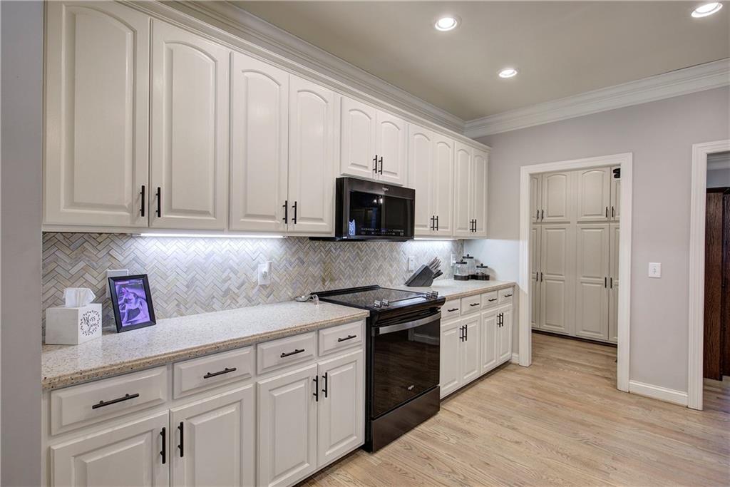 1005 Harmony Road Southeast Aragon, GA 30104 - Photo 14 of 40 a kitchen with granite countertop white cabinets and stainless steel appliances