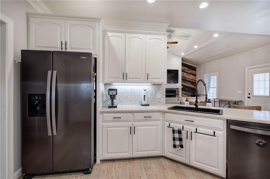 1005 Harmony Road Southeast Aragon, GA 30104 - Photo 19 of 40 a kitchen with stainless steel appliances a refrigerator sink and cabinets