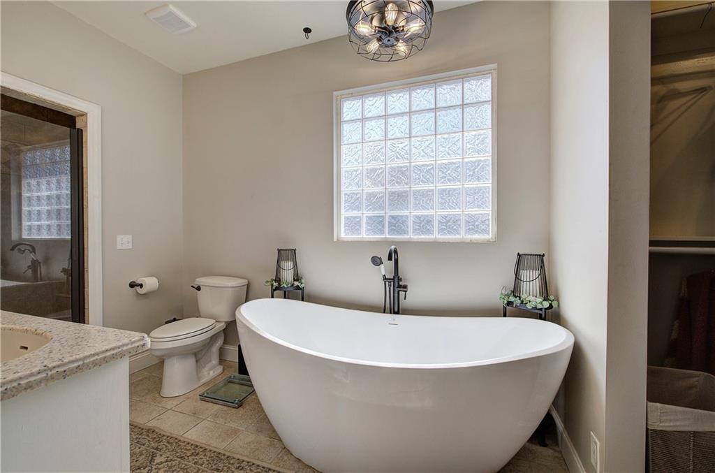 1005 Harmony Road Southeast Aragon, GA 30104 - Photo 27 of 40 a bath tub sitting next to a white toilet