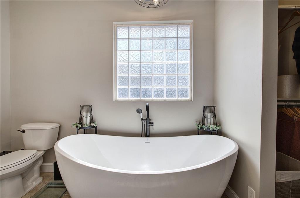 1005 Harmony Road Southeast Aragon, GA 30104 - Photo 29 of 40 a white tub sitting next to a white toilet