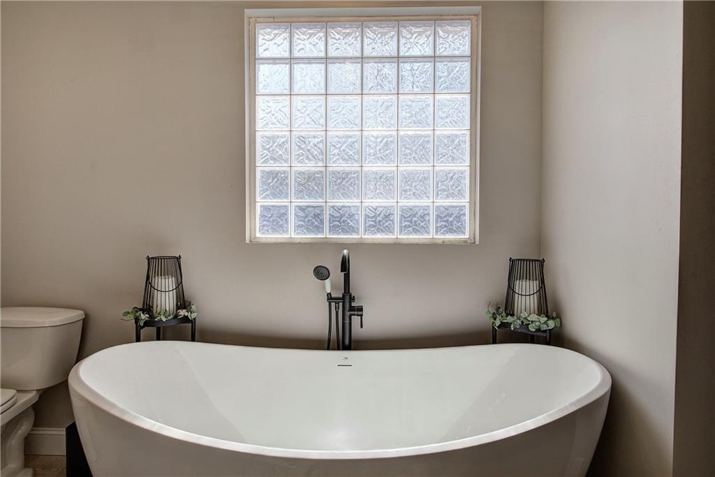 1005 Harmony Road Southeast Aragon, GA 30104 - Photo 30 of 40 a white bath tub sitting in a bathroom