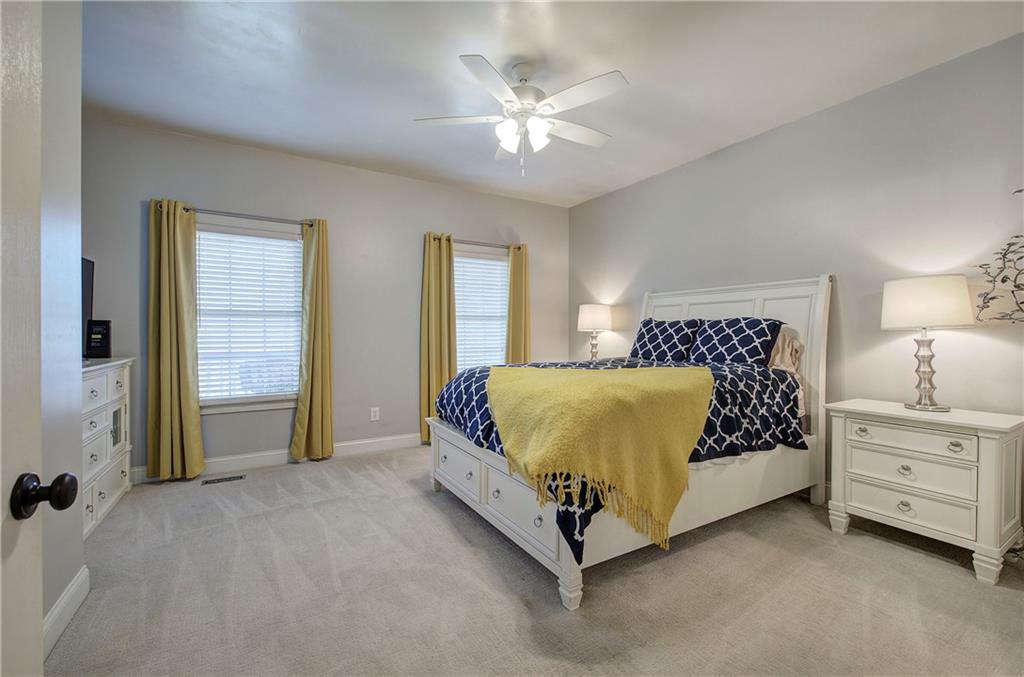 1005 Harmony Road Southeast Aragon, GA 30104 - Photo 34 of 40 a spacious bedroom with a bed and a ceiling fan