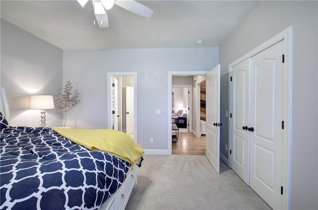 1005 Harmony Road Southeast Aragon, GA 30104 - Photo 35 of 40 a bedroom with a bed and a chandelier