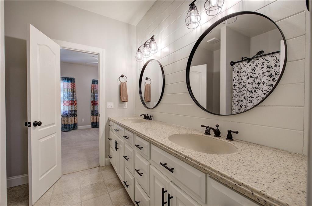 1005 Harmony Road Southeast Aragon, GA 30104 - Photo 36 of 40 a bathroom with a granite countertop double vanity sink and a mirror