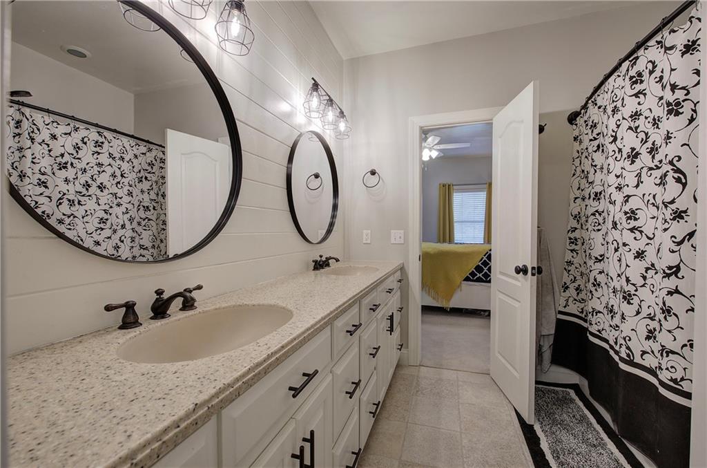 1005 Harmony Road Southeast Aragon, GA 30104 - Photo 37 of 40 a en suite bathroom with a double vanity sink and a mirror