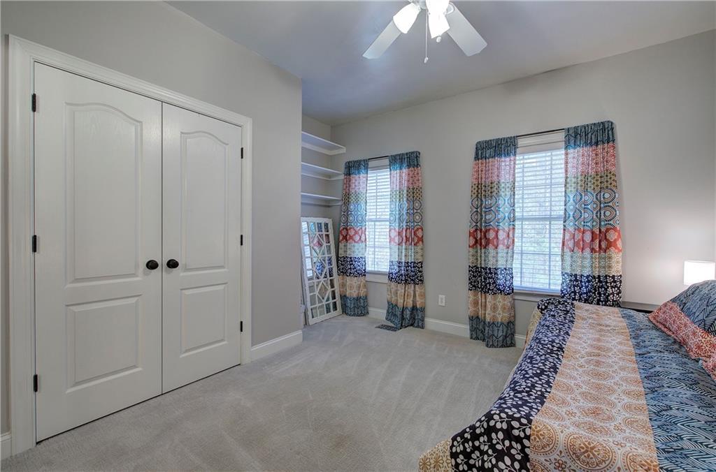 1005 Harmony Road Southeast Aragon, GA 30104 - Photo 38 of 40 a spacious bedroom with a bed and a chandelier
