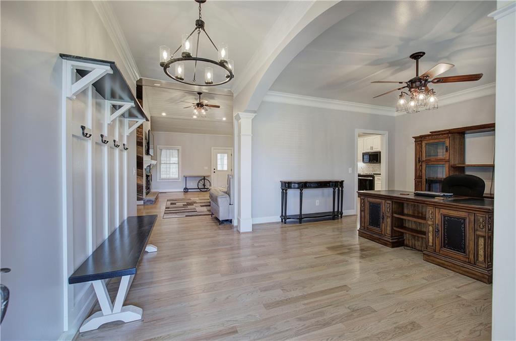 1005 Harmony Road Southeast Aragon, GA 30104 - Photo 4 of 40 a view of a livingroom with furniture a flat screen tv wooden floor and a ceiling fan