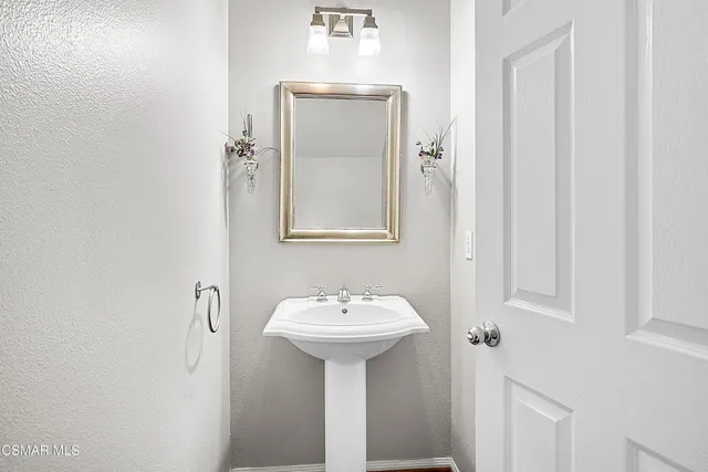 a bathroom with a sink a mirror and a toilet