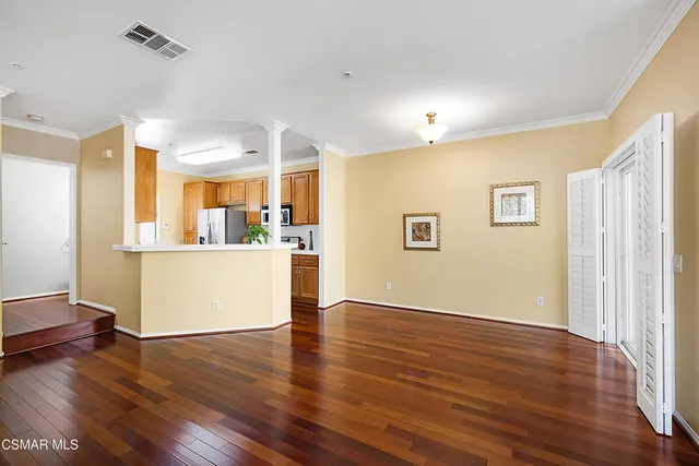 a view of a kitchen with wooden floor and a workspace