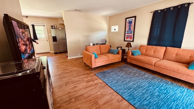4614 Raintree Boulevard Austin, TX 78745 - Photo 3 of 14 a living room with furniture and a flat screen tv