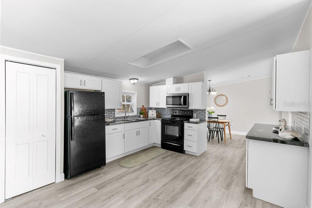 18137 Hollister Road Orlando, FL 32820 - Photo 8 of 27 a kitchen with stainless steel appliances a refrigerator stove microwave and sink