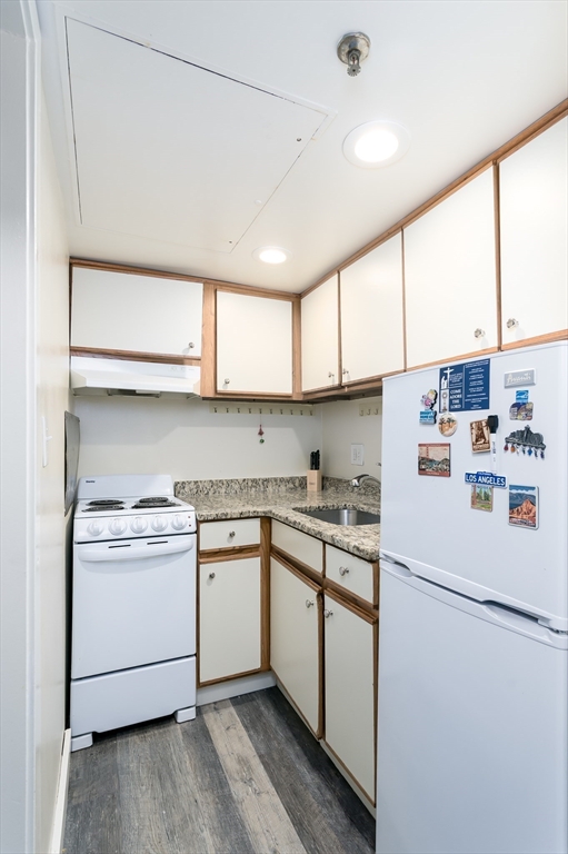 70 Southbridge Street, Unit 611 Worcester, MA 01608 - Photo 5 of 10 a utility room with stainless steel appliances granite countertop cabinets and a window